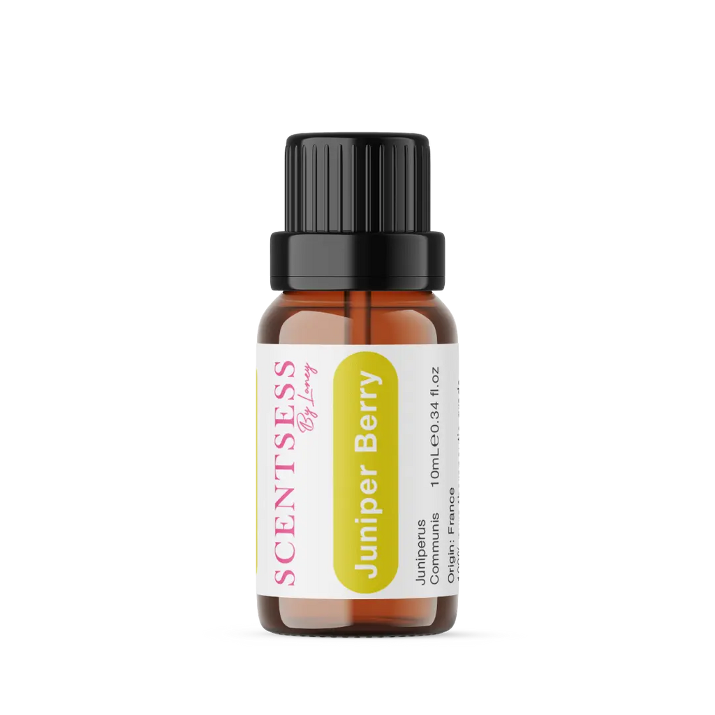Organic juniper berry essential oil bottle next to fresh blue juniper berries, representing a natural mind and body detox.